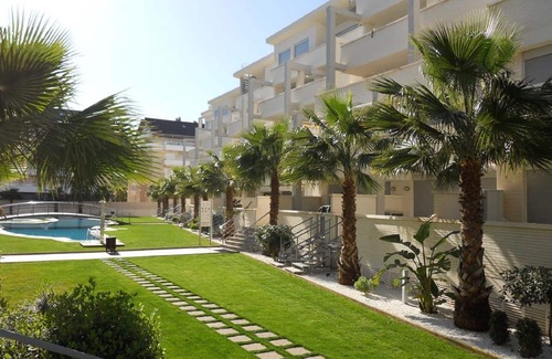 Denia Apartment | Modern apartment on the beach with large communal pool, fitness, air conditioning