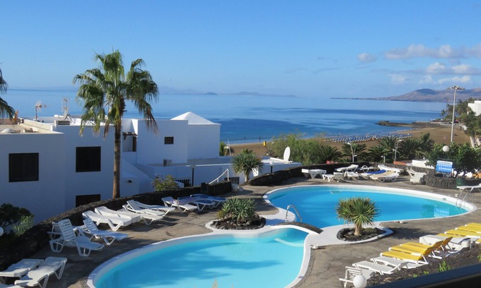 Puerto del Carmen Apartment | Front line, contemporary, newly refurbished, stunning sea views, pool, WiFi, SKY